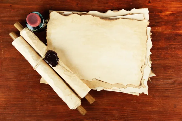 Old paper, ink and scrolls on wooden background — Stock Photo, Image