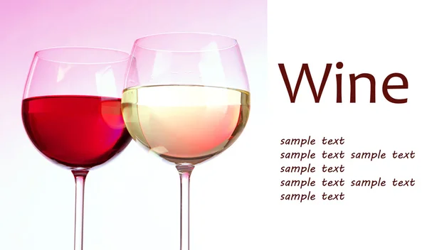 Two glasses with red and white wine on pink background — Stock Photo, Image