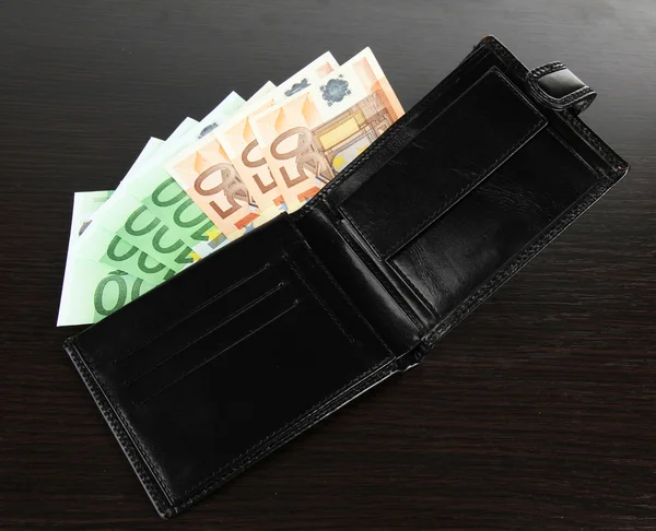 Euro in wallet on wooden background — Stock Photo, Image
