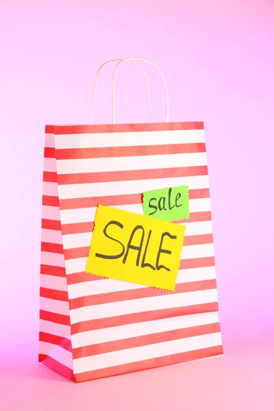 Striped bag on pink background — Stock Photo, Image