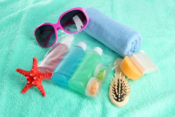 Hotel cosmetics kit on blue towel — Stock Photo, Image