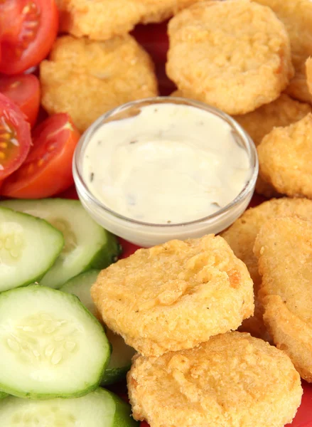 Fried chicken nuggets with vegetables and sauce isolated on white — Stock Photo, Image