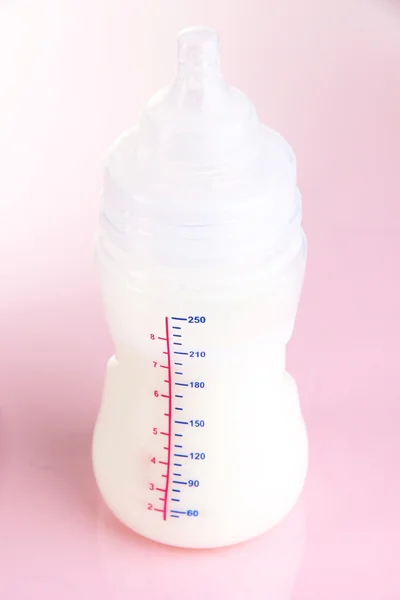 Bottle for milk formula on pink background — Stock Photo, Image