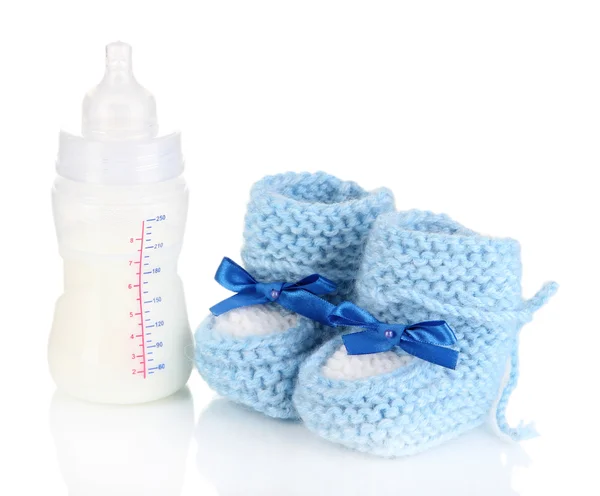 Bottle for milk formula with booties isolated on white — Stock Photo, Image