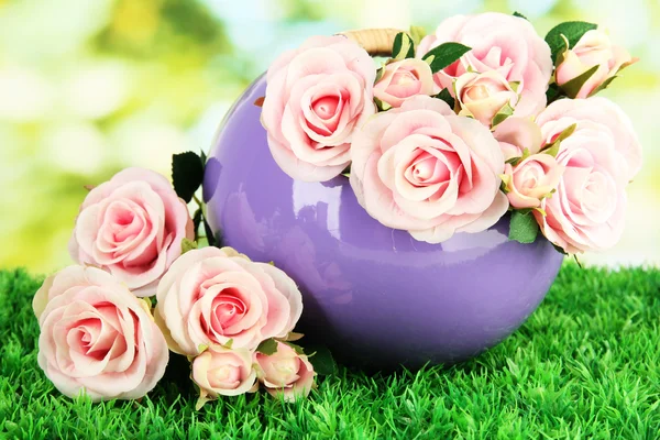 Pot with flowers on the grass on the nature background — Stock Photo, Image