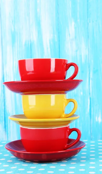 Three cups on blue background — Stock Photo, Image