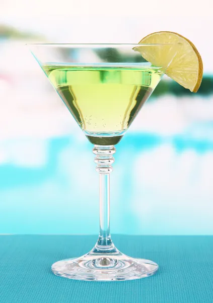 Green cocktail with lime on table on bright background — Stock Photo, Image