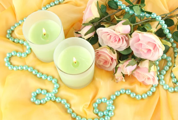 Candles on a yellow fabric close-up — Stock Photo, Image