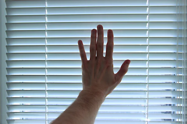 Hand on white blinds background — Stock Photo, Image