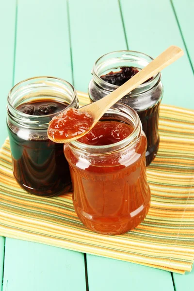Tasty jam in banks on table — Stock Photo, Image