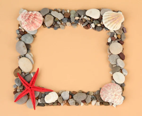 Frame of sea stones on color background — Stock Photo, Image