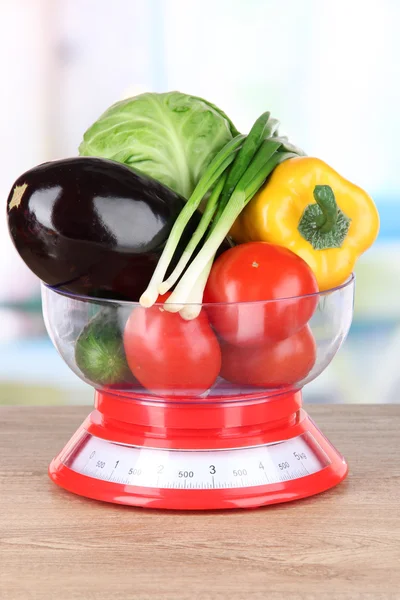 Fresh vegetables in scales on table in kitchen — Stock Photo, Image