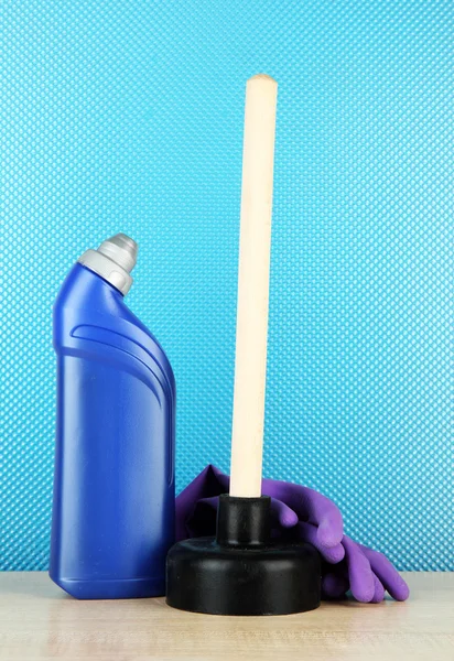 Toilet plunger, gloves and cleaner bottle on blue background — Stock Photo, Image