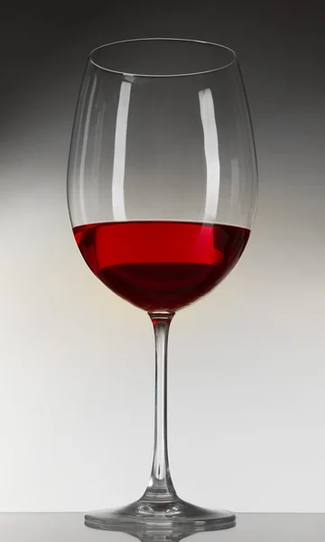 Glass of wine on gray background — Stock Photo, Image