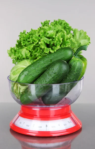 Fresh vegetables in scales on gray background — Stock Photo, Image