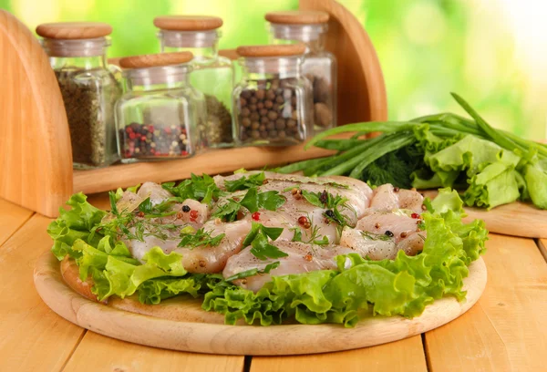 Chicken meat on wooden board,herbs and spices on wooden table — Stock Photo, Image