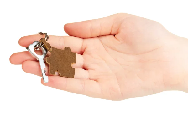 Key with leather trinket in hand isolated on white — Stock Photo, Image