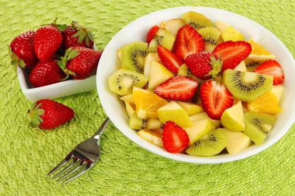 Salada de frutas útil de frutas frescas e bagas em tigela em guardanapo isolado em branco — Fotografia de Stock