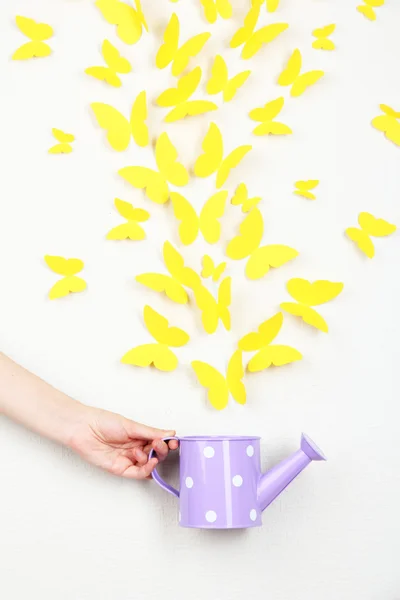 Paper yellow butterflies fly out of watering can — Stock Photo, Image