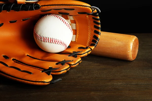 Baseball glove, bat and ball on dark background — Stock Photo, Image