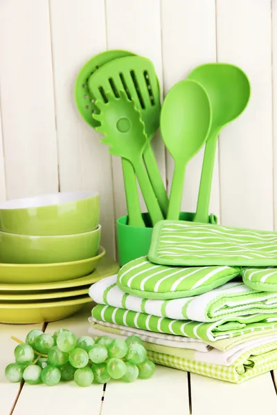 Kitchen settings: utensil, potholders, towels and else on wooden table — Stock Photo, Image