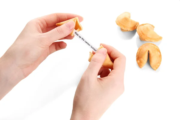 Mulher segurando biscoito da sorte, isolado no branco — Fotografia de Stock