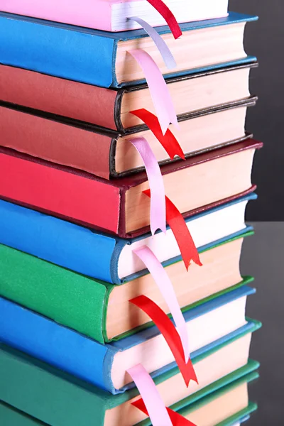 Many books with bookmarks on gray background — Stock Photo, Image