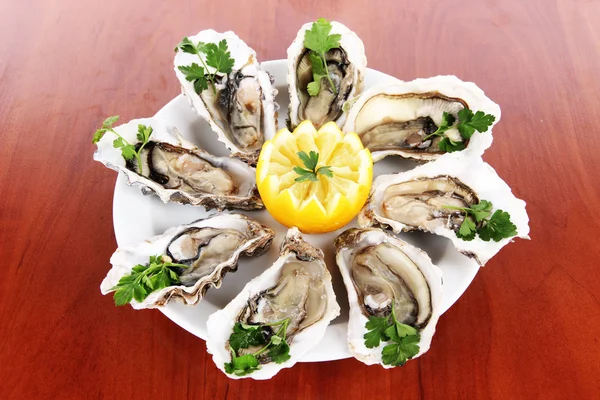 Oysters on wooden background — Stock Photo, Image