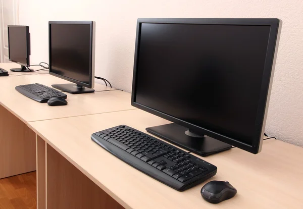 Computers on tables in room — Stock Photo, Image