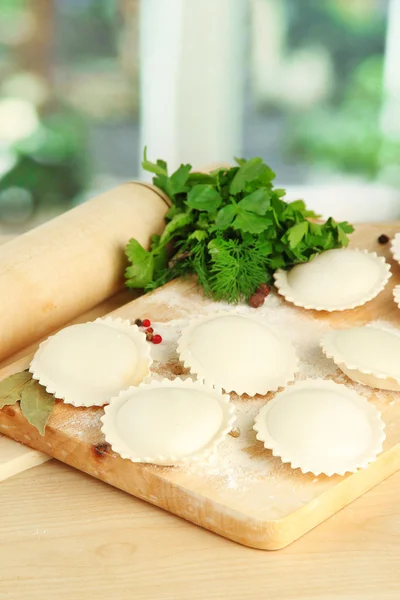 Raw dumplings and dough, on wooden table — Stock Photo, Image