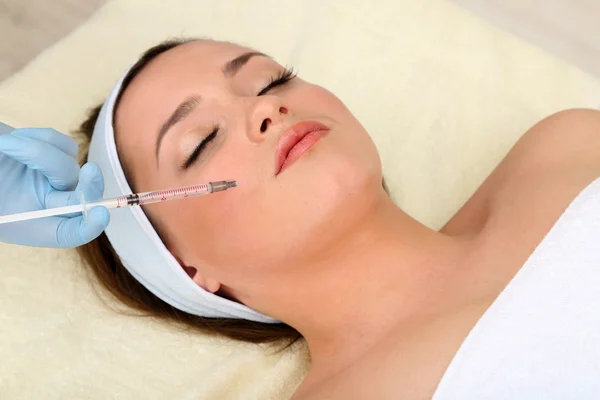 Young woman receiving plastic surgery injection on her face close up — Stock Photo, Image