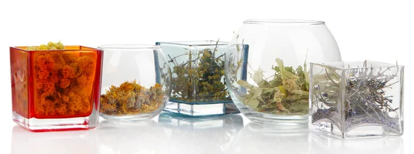 Ervas secas em recipientes de vidro isolados sobre branco — Fotografia de Stock