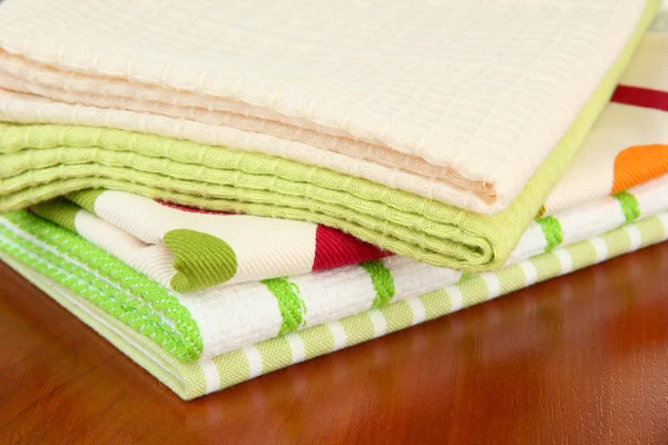 Kitchen towels on wooden background — Stockfoto