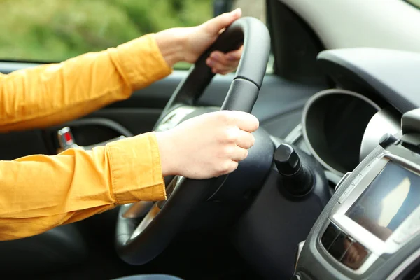 Mãos femininas sobre uma roda no carro, close-up — Fotografia de Stock
