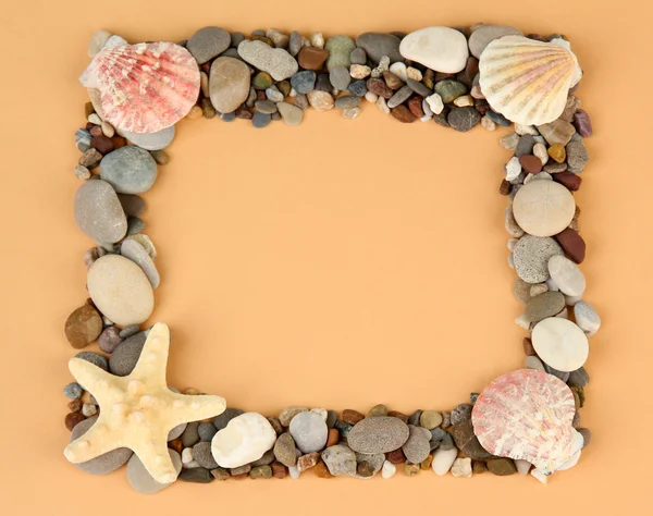 Frame of sea stones on color background — Stock Photo, Image