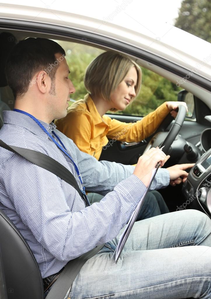 Learner driver student driving car with instructor