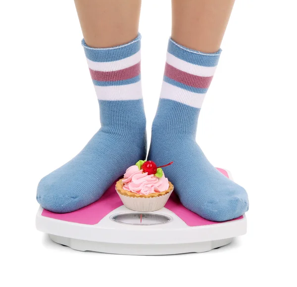 Female feet on scales, isolated on white — Stock Photo, Image