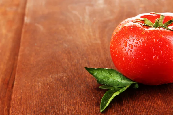 Fresh tomato on wooden background — Stock Photo, Image