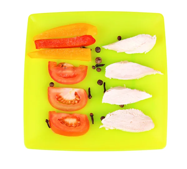 Preparing chicken stir fry with vegetables and spices on color plate, isolated on white — Stock Photo, Image