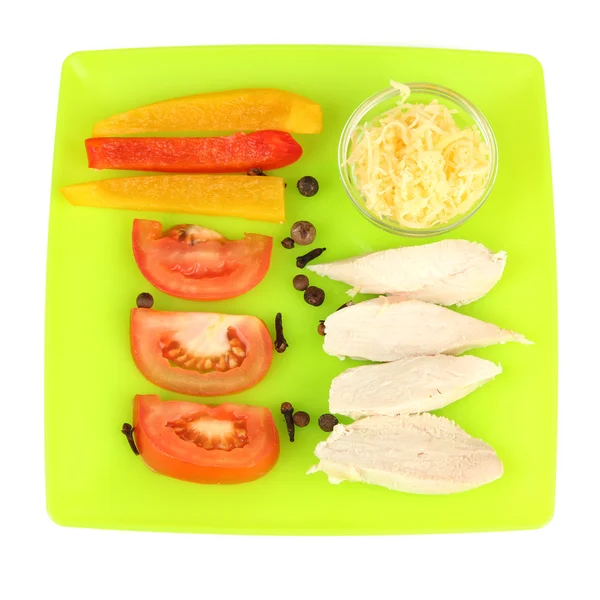 Preparing chicken stir fry with vegetables and spices on color plate, isolated on white — Stock Photo, Image