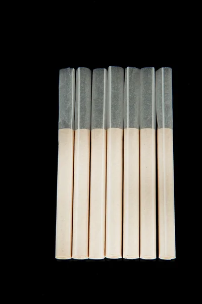 Empty cigarette tubes, isolated on black — Stock Photo, Image