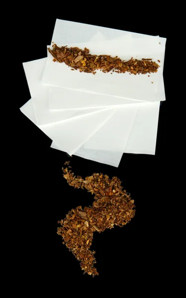 Tobacco and rolling paper, isolated on black — Stock Photo, Image