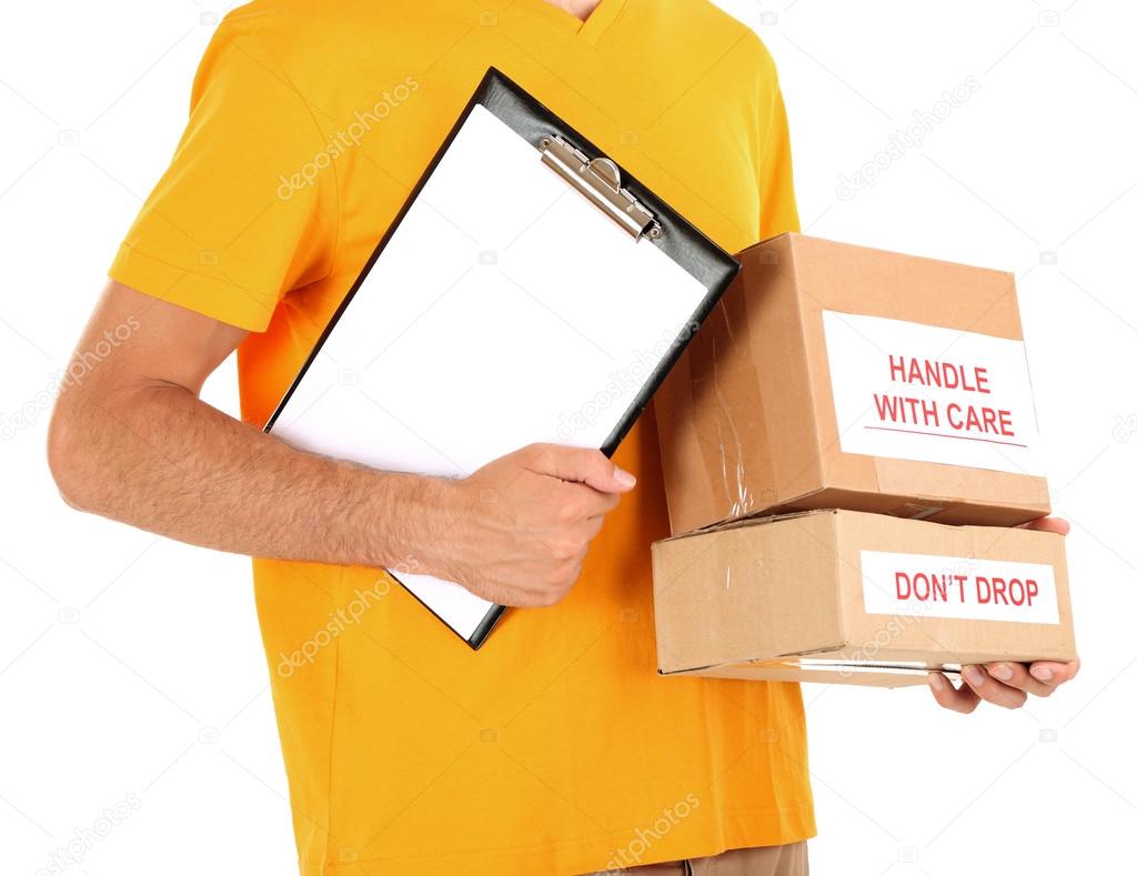 Young delivery man holding parcels and clipboard, isolated on white