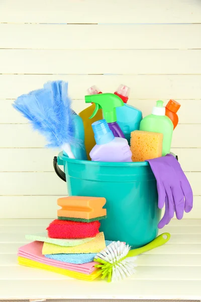 Cleaning items in bucket on white wooden background — Stock Photo, Image