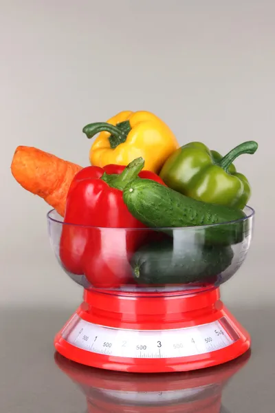 Fresh vegetables in scales on gray background — Stock Photo, Image