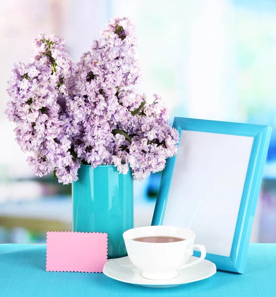 Beautiful lilac flowers on table in room — Stock Photo, Image