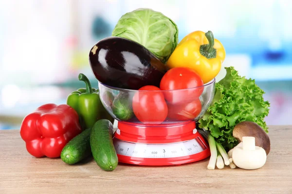 Fresh vegetables in scales on table in kitchen — Stock Photo, Image