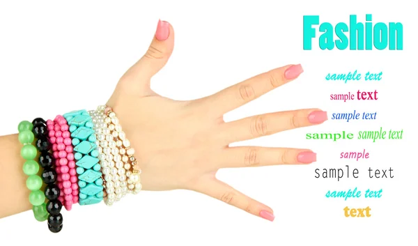 Vrouwelijke hand met roze manicure en heldere armbanden, geïsoleerd op wit — Stockfoto
