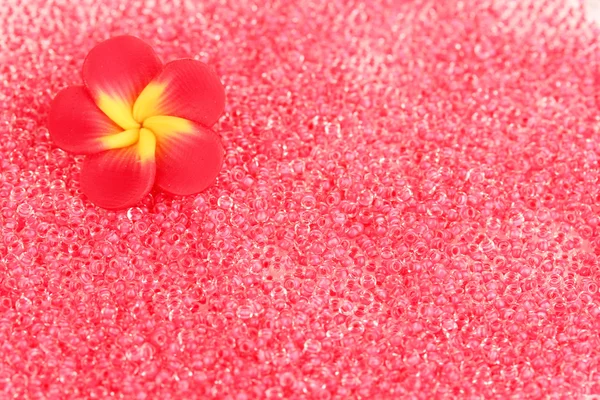 Red beads with decorative handmade flower closeup — Stock Photo, Image