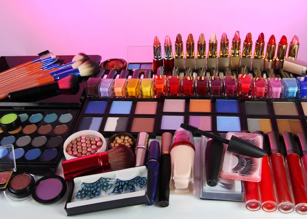 Lot of different cosmetics on pink background — Stock Photo, Image